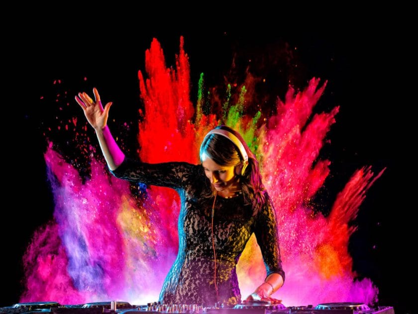 DJ performing with paint splashes in the background